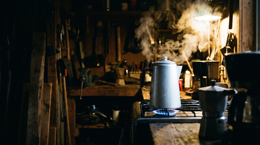 Titanium percolator on a blue gas flame in an early morning kitchen